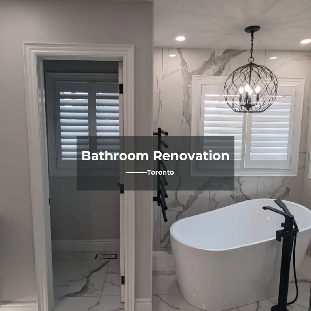 Freestanding soaker tub with black matte floor-mount faucet and Calacatta marble wall tile Toronto