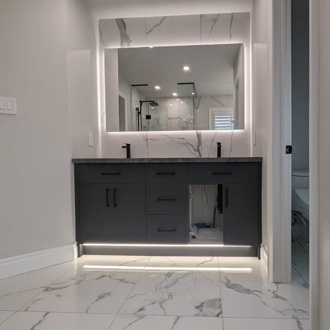 Double vanity with LED backlit mirror and under-cabinet lighting Toronto master bathroom