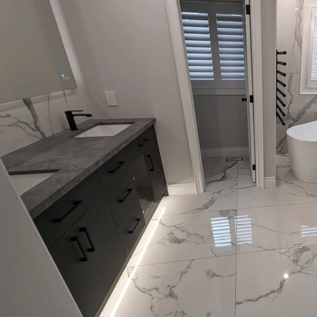 Frameless glass shower with black rain head Toronto master bathroom