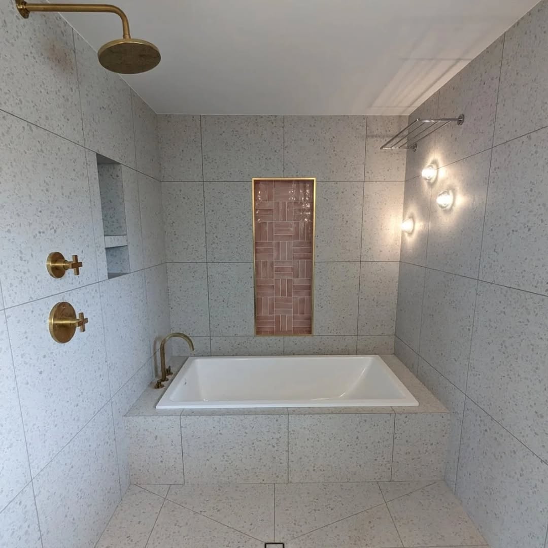 Full master bathroom with terrazzo porcelain shower walls and wood plank floor Toronto