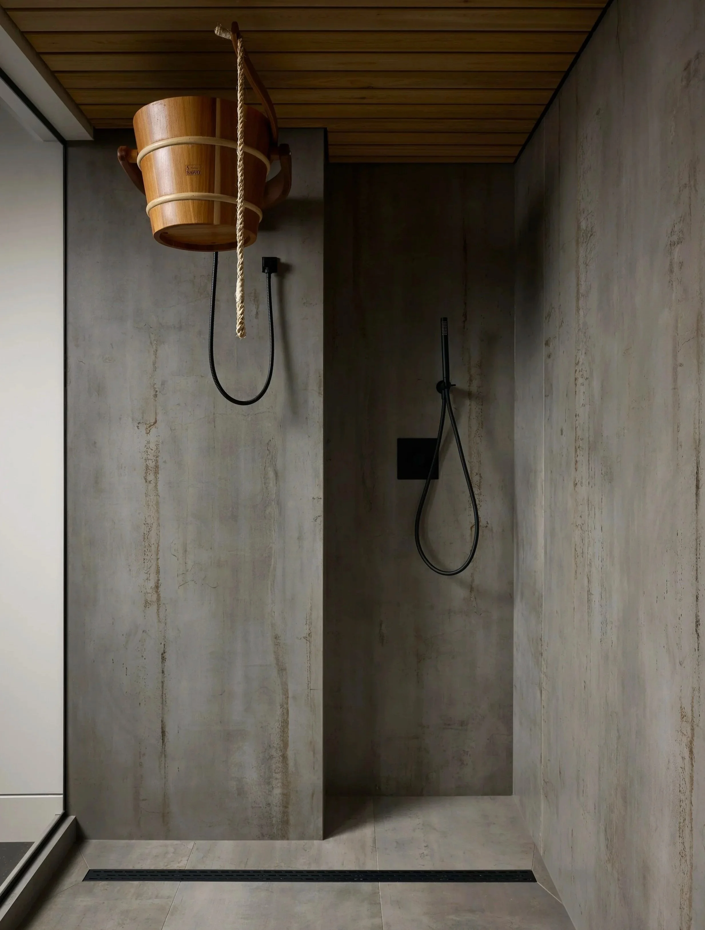 Cedar sauna with concrete-look porcelain and black matte fixtures Toronto